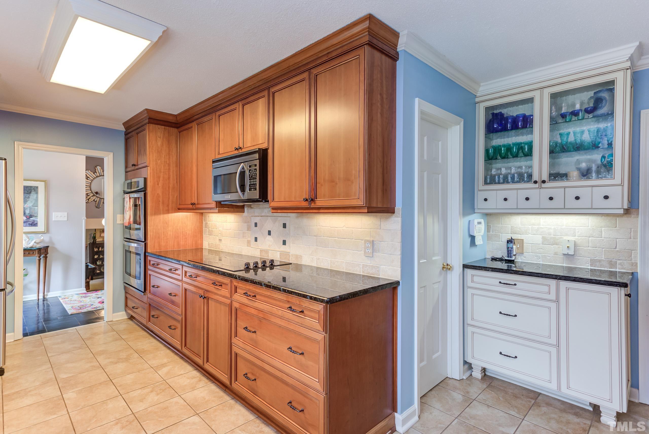 2509 Catalina Court Raleigh, NC 27607 - Photo 8 of 29 a kitchen with granite countertop stainless steel appliances a stove sink and cabinets