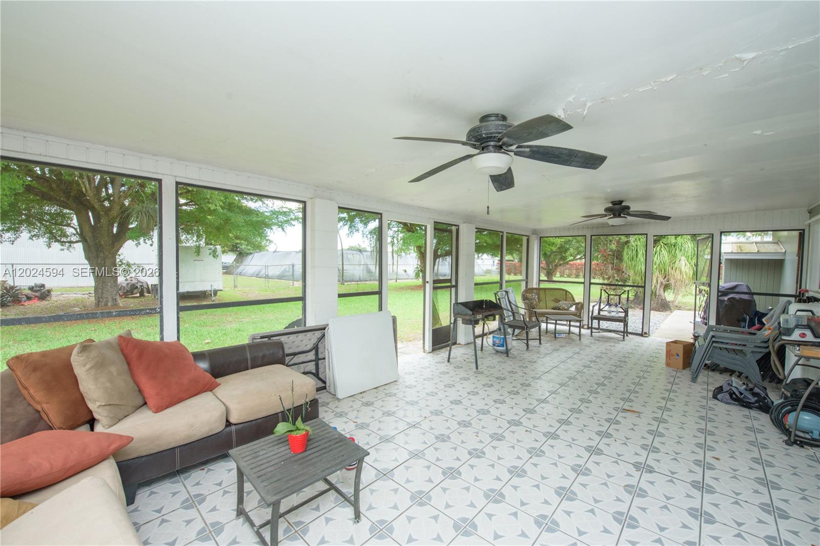 17355 Southwest 256th Street Homestead, FL 33031 - Photo 15 of 32 a living room with furniture and a large window