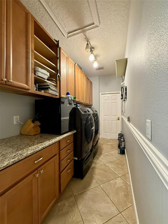 1849 Watermere Lane Windermere, FL 34786 - Photo 17 of 31 a utility room with granite countertop cabinets and washer