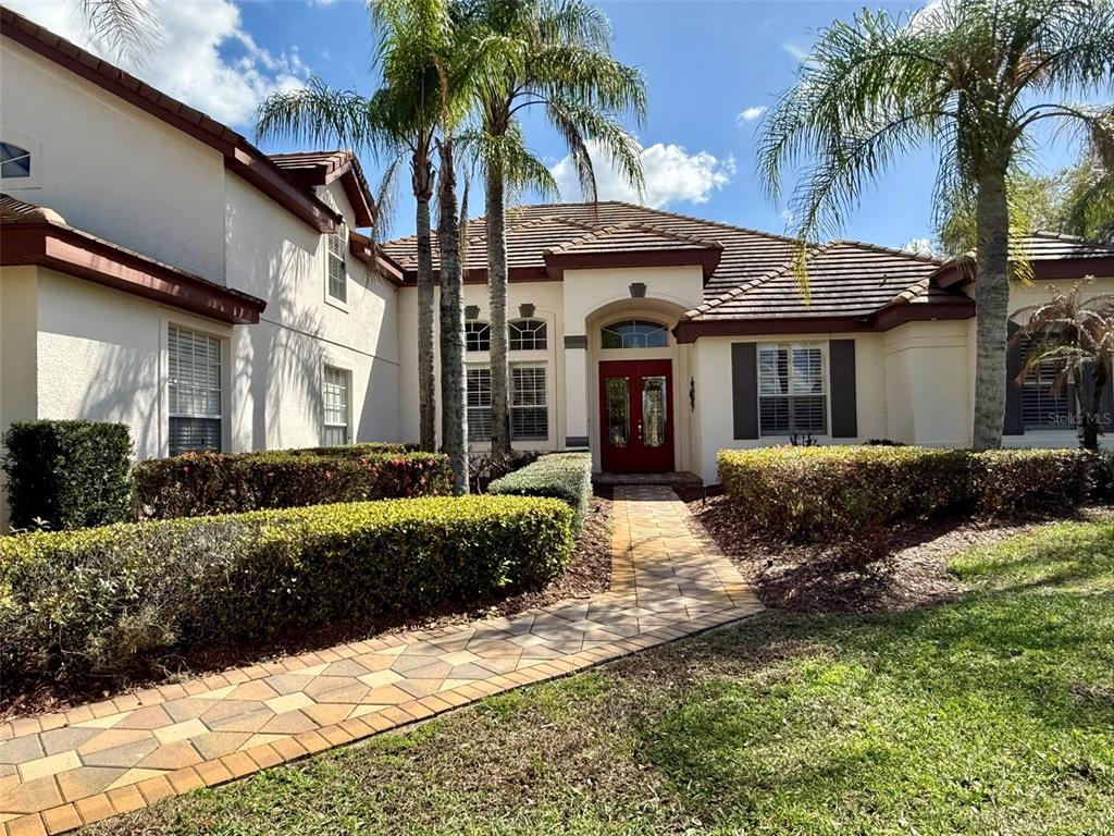1849 Watermere Lane Windermere, FL 34786 - Photo 2 of 31 a front view of a house with garden and porch