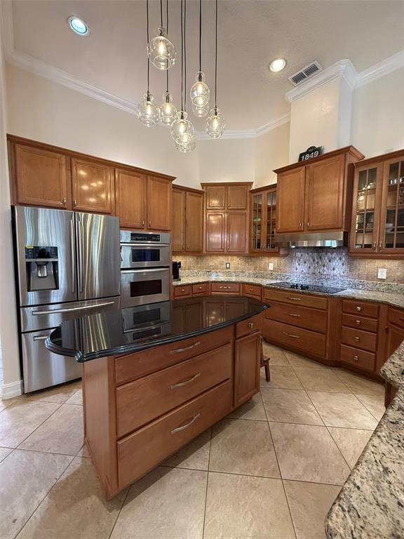 1849 Watermere Lane Windermere, FL 34786 - Photo 6 of 31 a kitchen with stainless steel appliances wooden cabinets a refrigerator and a sink
