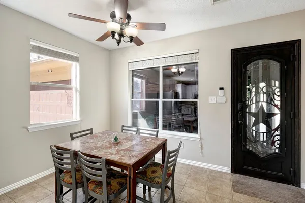 a dining room with furniture and window