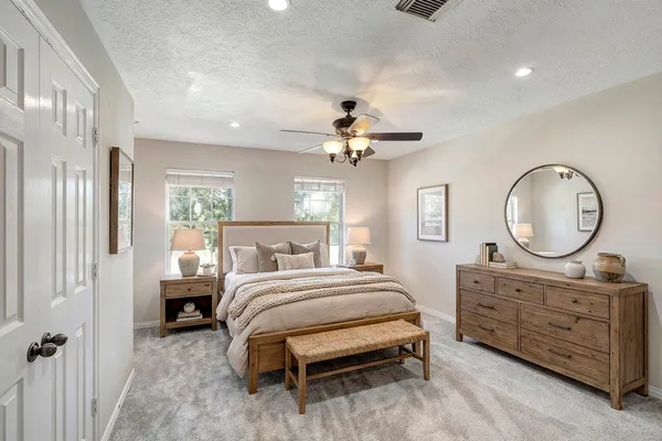 a bedroom with a bed and a chandelier