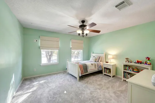 a bed room with a bed and a chandelier