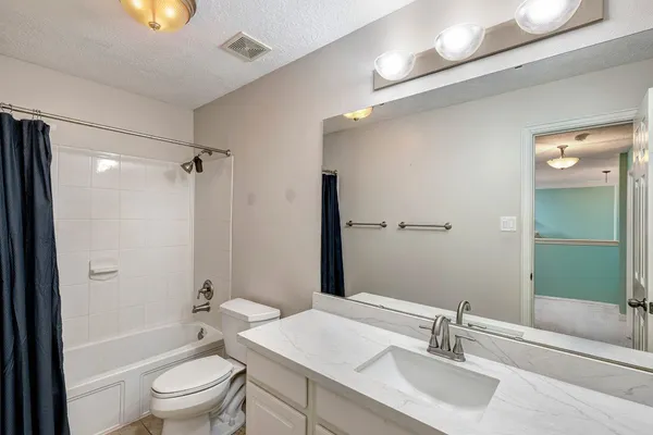 a bathroom with a sink toilet tub and shower
