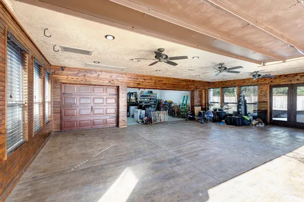 a view of a big room with windows and a garage