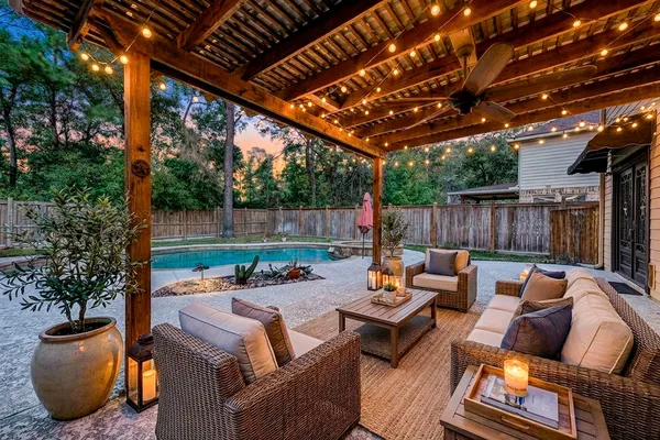 a backyard of a house with fire pit and outdoor seating