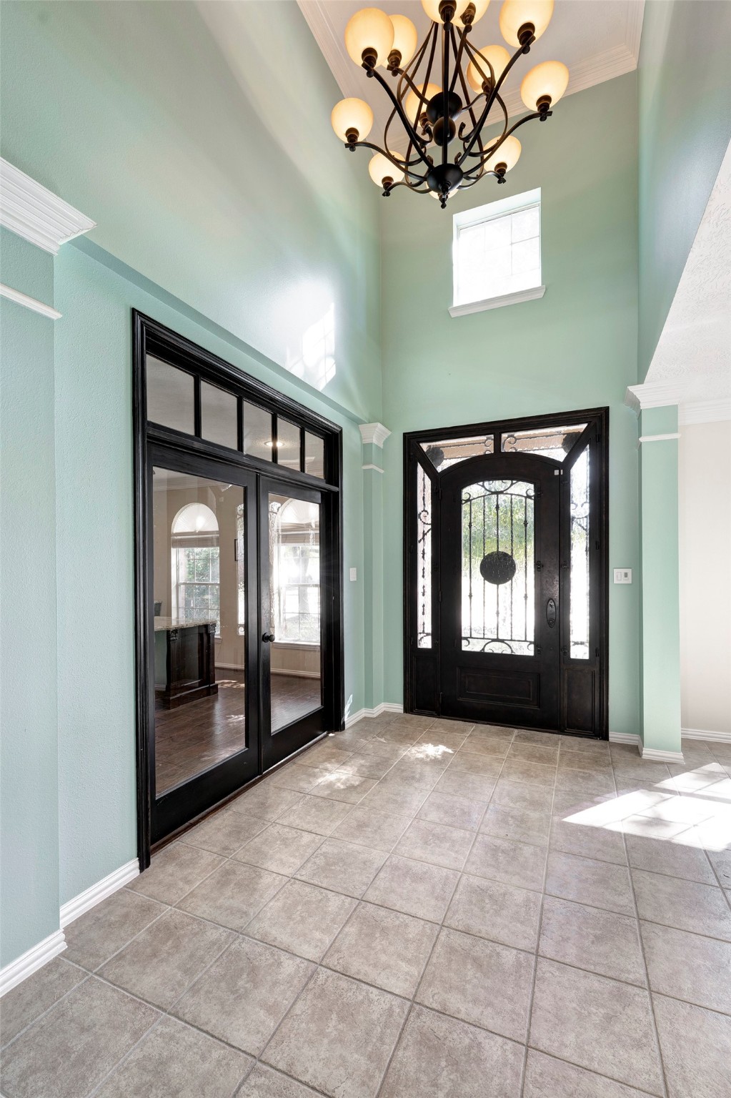 2511 Bridgestone Park Lane Spring, TX 77386 - Photo 3 of 25 Step through a custom iron and glass entry door into a two-story foyer.