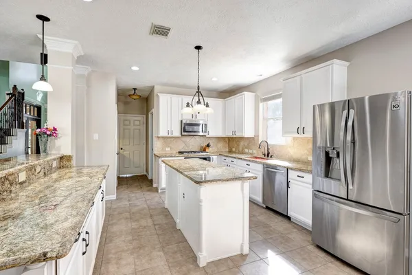 a kitchen with a refrigerator a sink and a stove