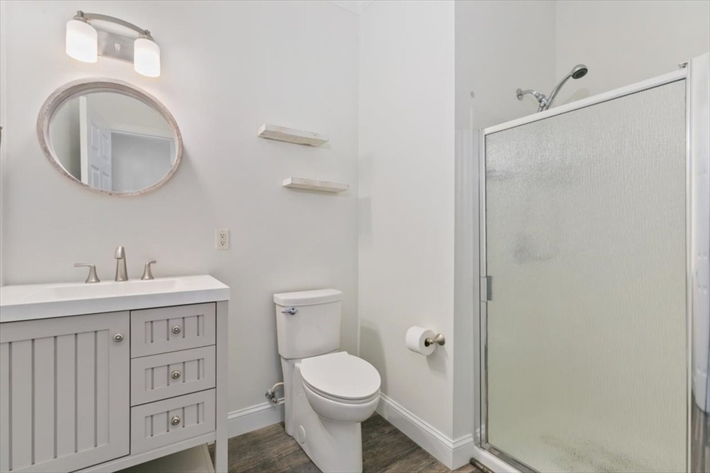 21 Hampshire Road, Unit 313 Methuen, MA 01844 - Photo 15 of 35 a bathroom with a toilet a sink and a mirror