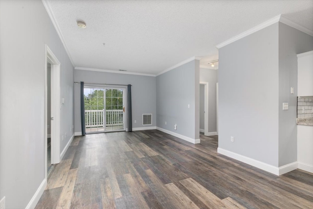 21 Hampshire Road, Unit 313 Methuen, MA 01844 - Photo 2 of 35 wooden floor in an empty room with a window