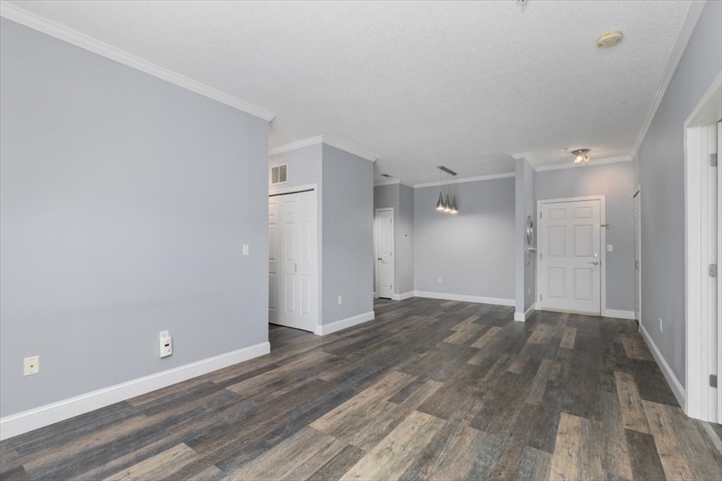 21 Hampshire Road, Unit 313 Methuen, MA 01844 - Photo 3 of 35 a view of an empty room and wooden floor