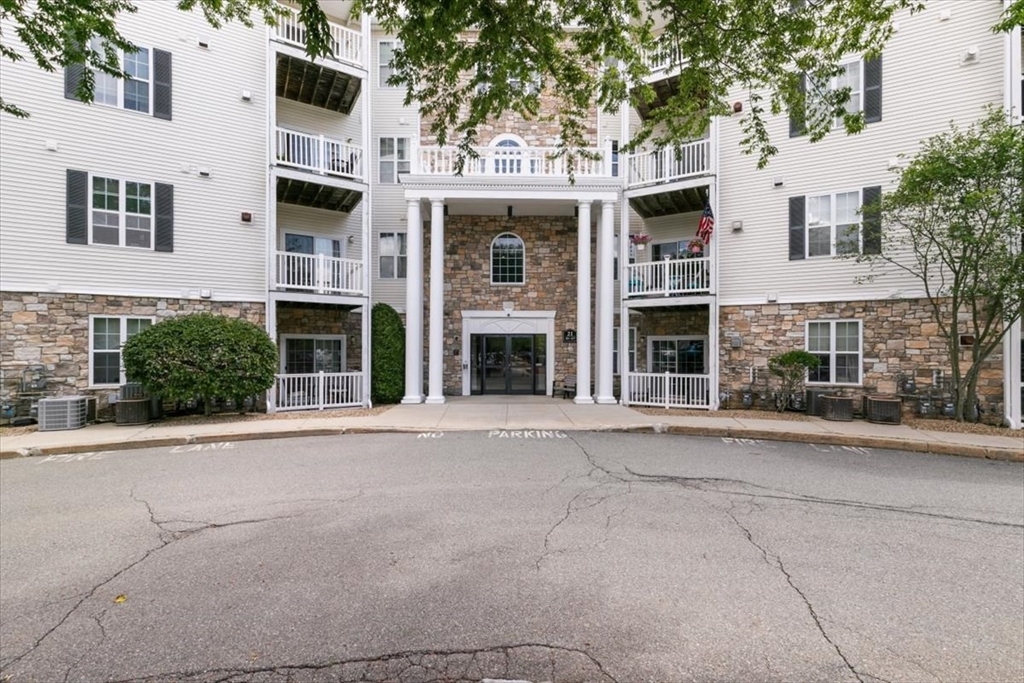 21 Hampshire Road, Unit 313 Methuen, MA 01844 - Photo 32 of 35 a front view of a building with a street