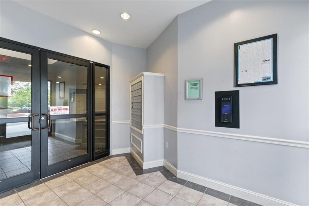 21 Hampshire Road, Unit 313 Methuen, MA 01844 - Photo 33 of 35 a view of a hallway with wooden floor and a bathroom
