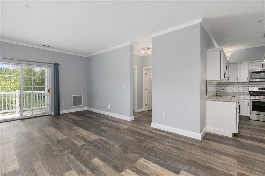 21 Hampshire Road, Unit 313 Methuen, MA 01844 - Photo 4 of 35 a view of an empty room with a window