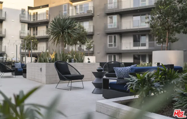 a view of a patio with table and chairs and potted plants