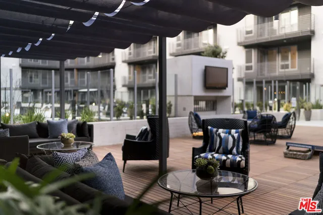 a view of a patio with dining table and chairs