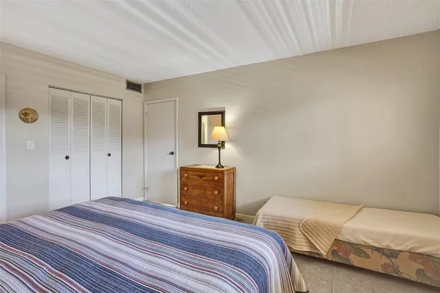 a bedroom with a bed and a lamp