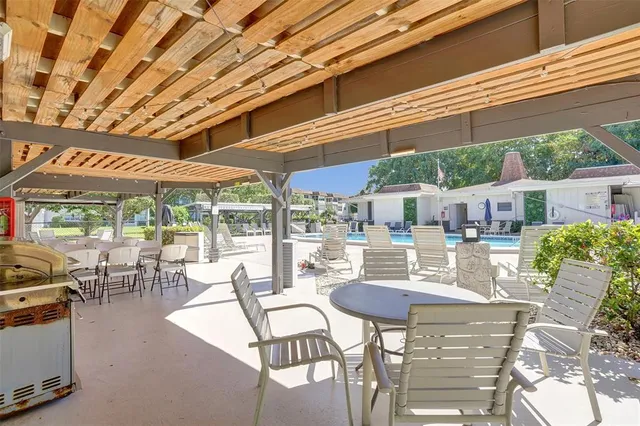 a view of a patio with a table and chairs and potted plants