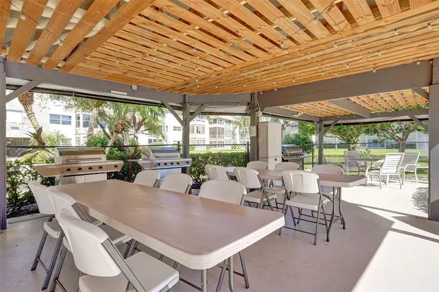 a view of a dining room with furniture wooden floor and a potted plant