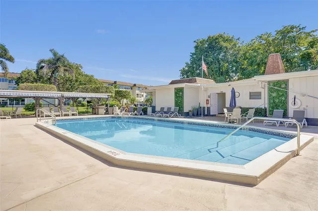 a view of house with outdoor space and swimming pool