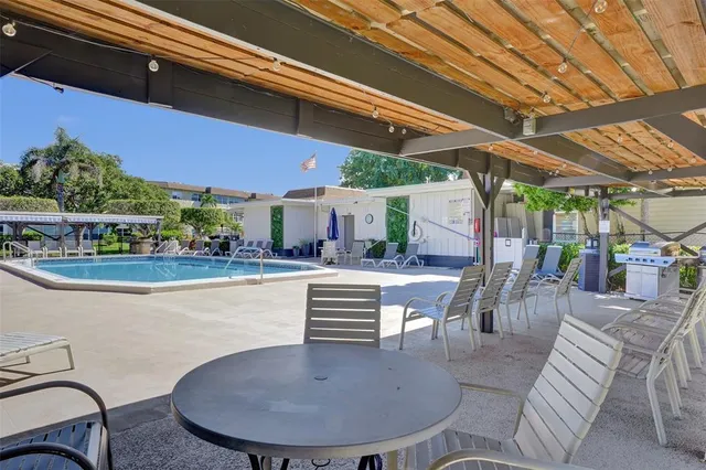 a view of a swimming pool with outdoor seating