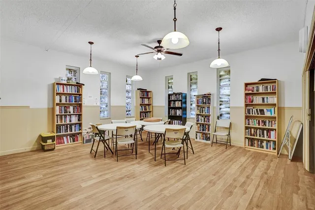 a view of a room with furniture and wooden floor