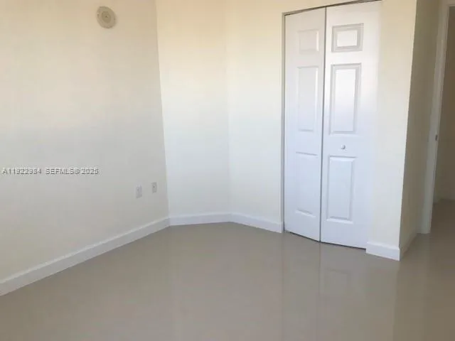 an empty room with closet area