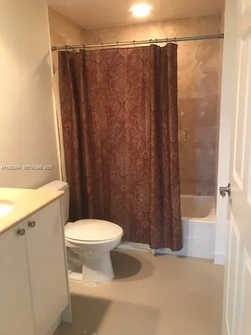 a bathroom with a shower and a toilet