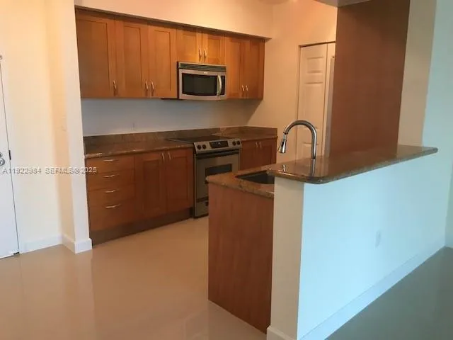 a kitchen with a microwave and a refrigerator