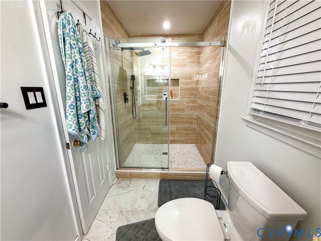 13727 Nashua Terrace Midlothian, VA 23112 - Photo 21 of 33 a bathroom with a sink a toilet a tub and shower