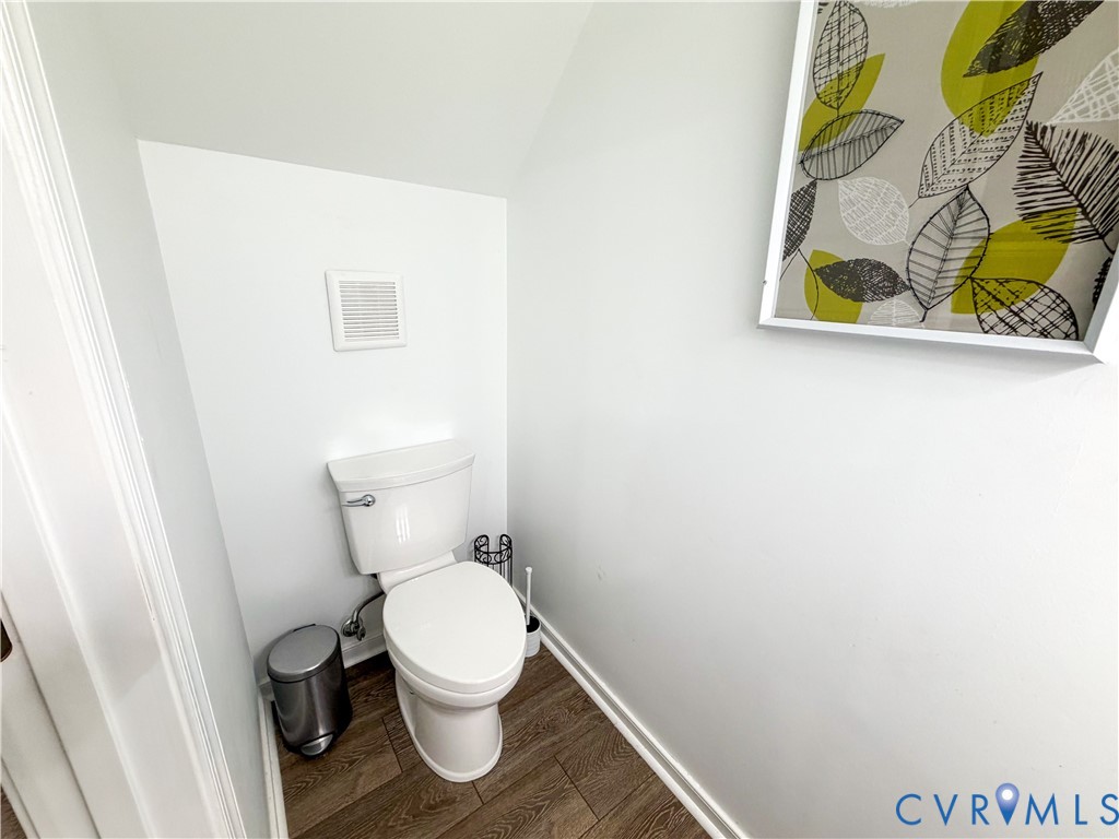 13727 Nashua Terrace Midlothian, VA 23112 - Photo 7 of 33 a white toilet sitting next to a wooden floor