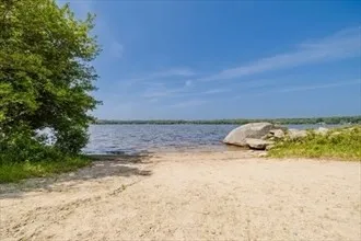 a view of ocean beach and mountain