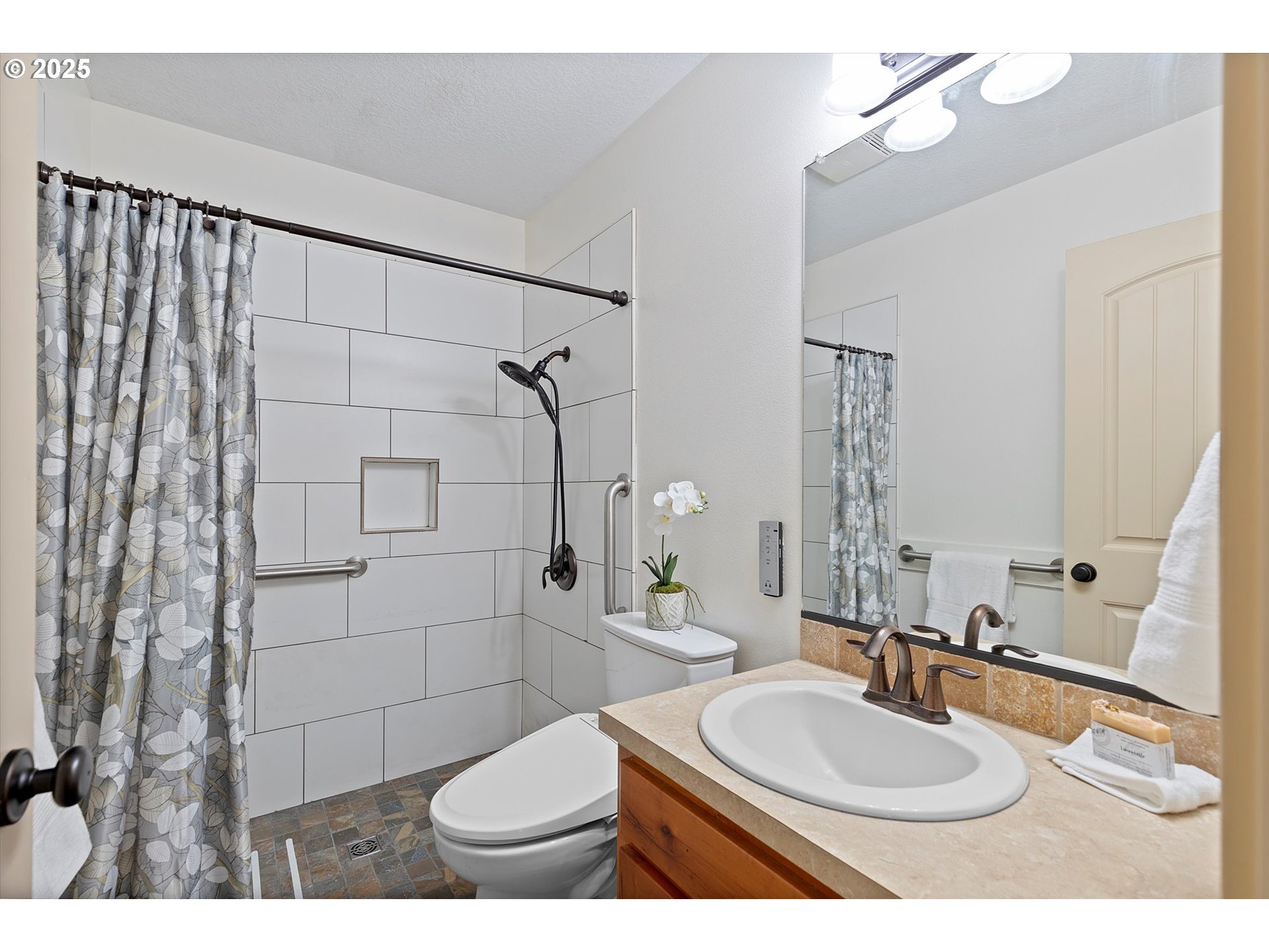 723 North 7th Street Carlton, OR 97111 - Photo 11 of 32 a bathroom with a sink toilet a mirror and shower