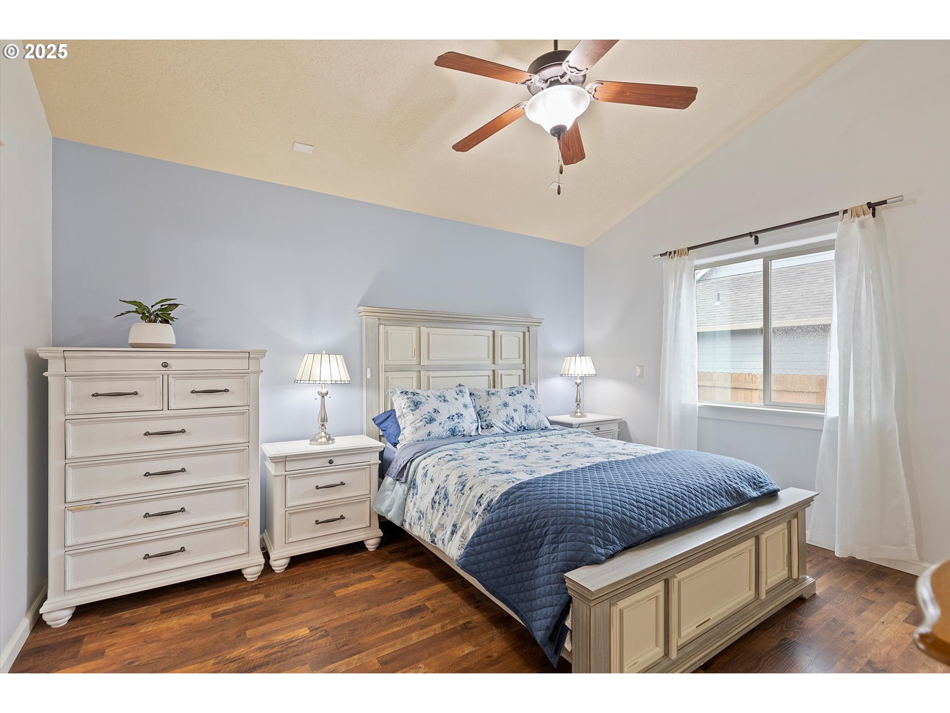 723 North 7th Street Carlton, OR 97111 - Photo 18 of 32 a bedroom with a bed a dresser and a window