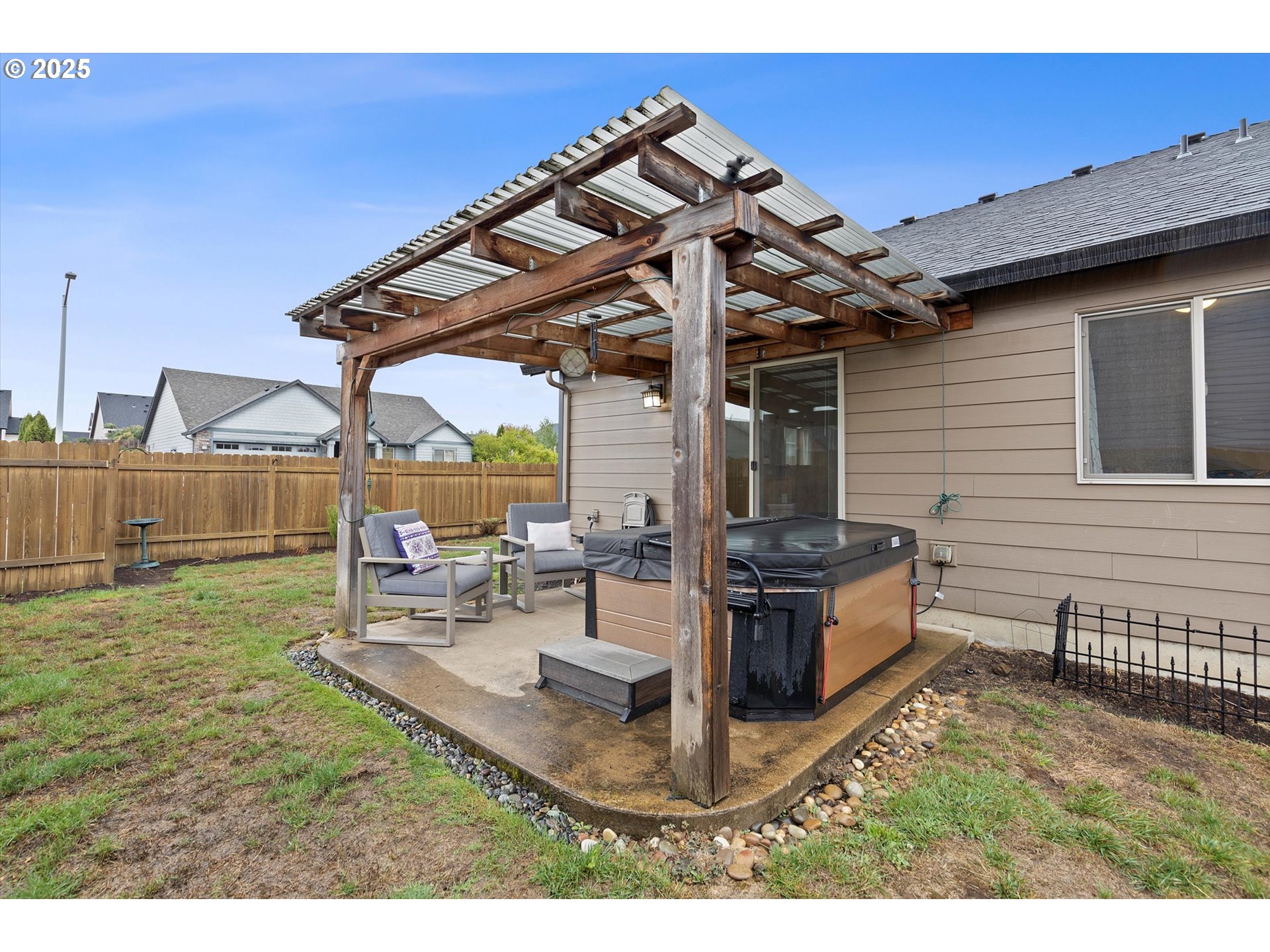 723 North 7th Street Carlton, OR 97111 - Photo 27 of 32 a view of a backyard with table and chairs potted plants and a barbeque grill