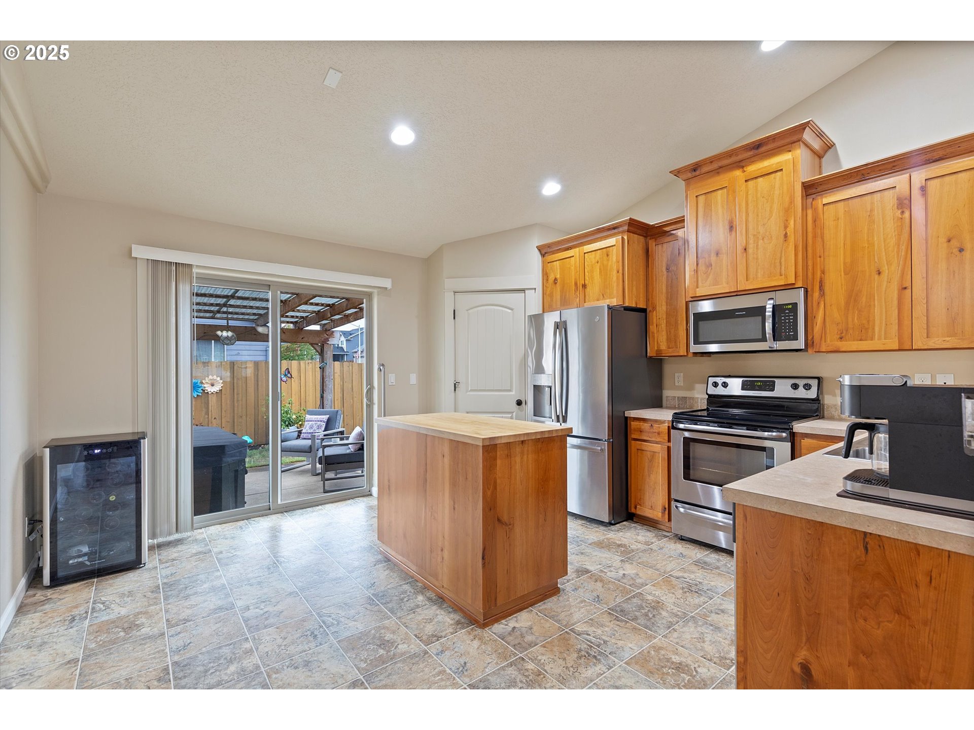 723 North 7th Street Carlton, OR 97111 - Photo 7 of 32 a kitchen with stainless steel appliances kitchen island granite countertop a refrigerator oven stove a sink and dishwasher