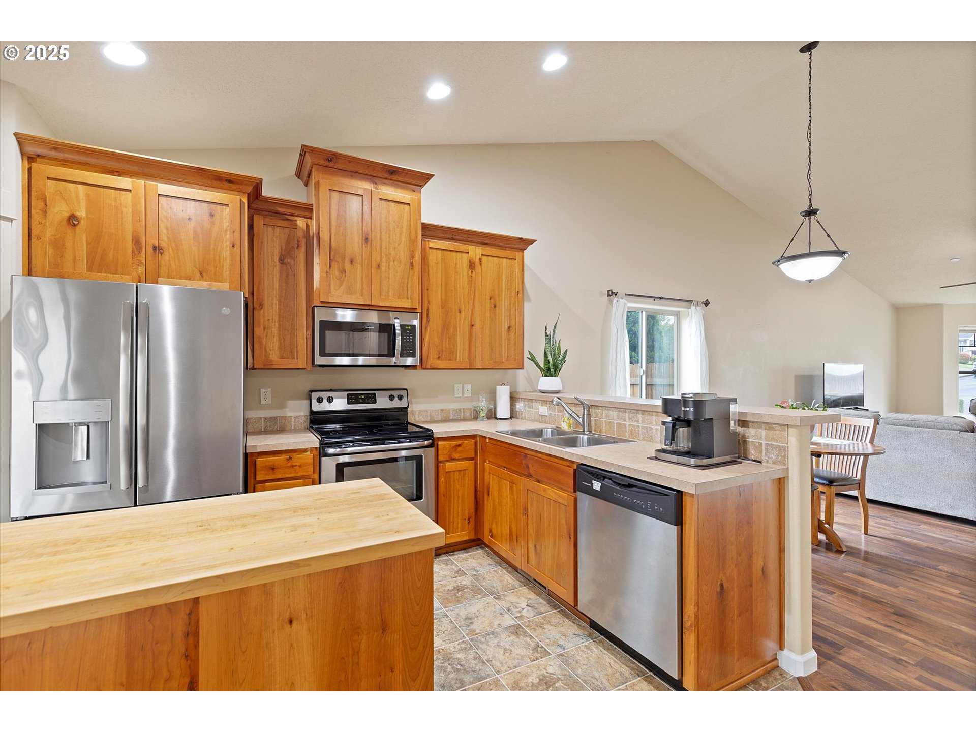 723 North 7th Street Carlton, OR 97111 - Photo 8 of 32 a kitchen with a refrigerator a sink dishwasher with a dining table and chairs