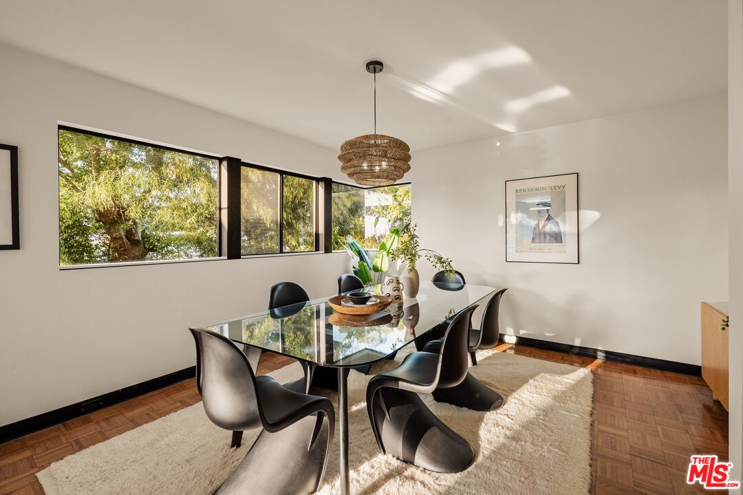 4303 San Rafael Avenue Los Angeles, CA 90042 - Photo 13 of 74 a dining room with furniture a chandelier and wooden floor