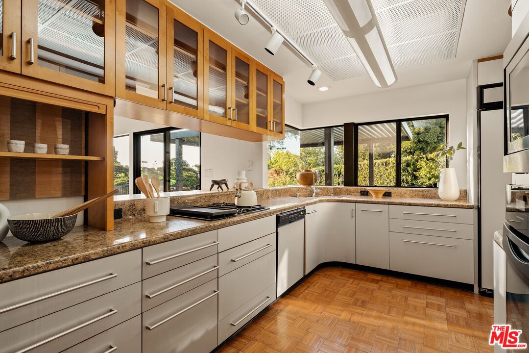 4303 San Rafael Avenue Los Angeles, CA 90042 - Photo 16 of 74 a kitchen with granite countertop white cabinets and white appliances