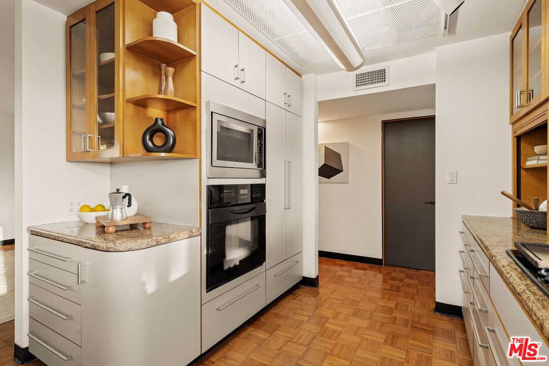 4303 San Rafael Avenue Los Angeles, CA 90042 - Photo 18 of 74 a kitchen with stainless steel appliances a stove a microwave and a refrigerator