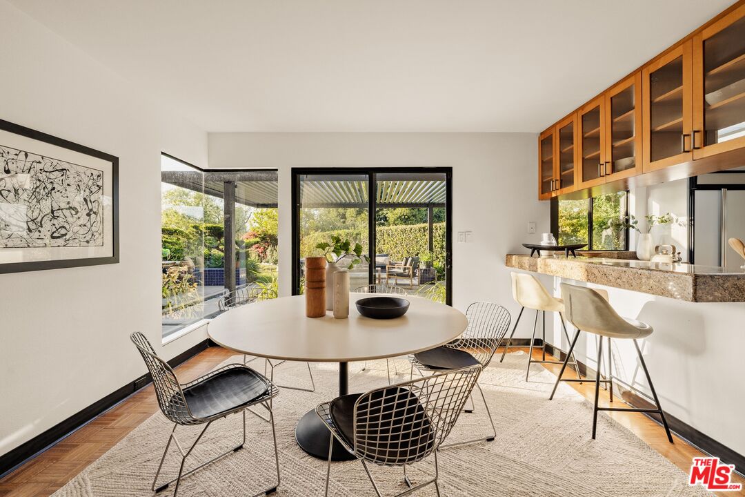 4303 San Rafael Avenue Los Angeles, CA 90042 - Photo 24 of 74 a dining room with furniture a rug and wooden floor