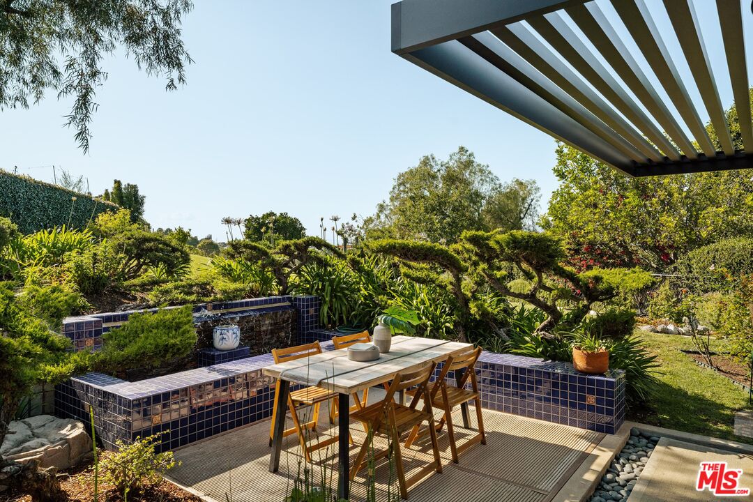 4303 San Rafael Avenue Los Angeles, CA 90042 - Photo 28 of 74 a patio with table and chairs and potted plants