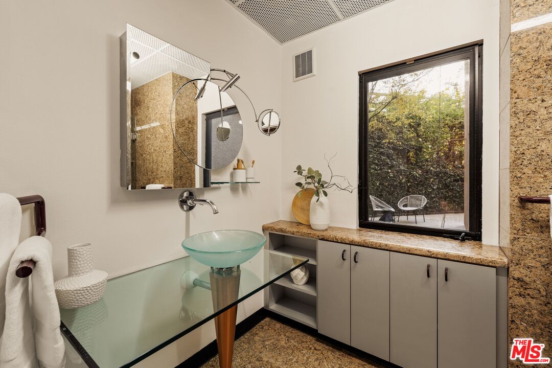 4303 San Rafael Avenue Los Angeles, CA 90042 - Photo 38 of 74 a bathroom with a sink mirror and a bathtub
