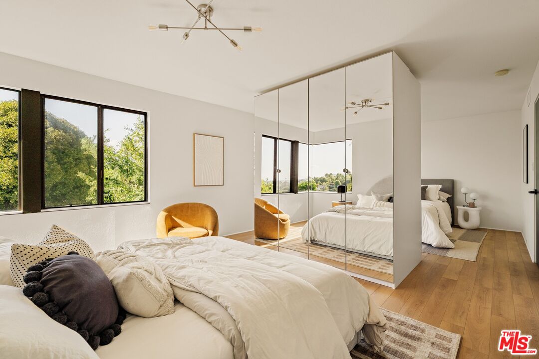 4303 San Rafael Avenue Los Angeles, CA 90042 - Photo 48 of 74 a bedroom with a bed and wooden floor