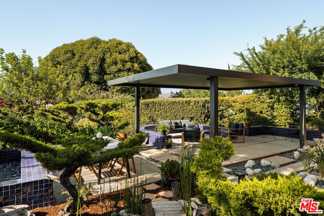 4303 San Rafael Avenue Los Angeles, CA 90042 - Photo 55 of 74 a view of a patio with table and chairs under an umbrella