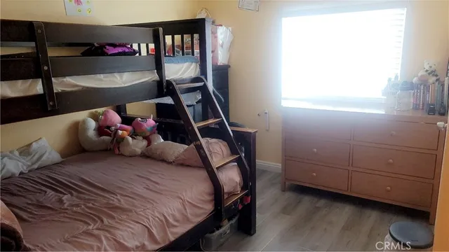 a bedroom with a bed and large window