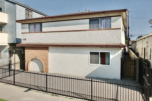 a view of a house with iron fence