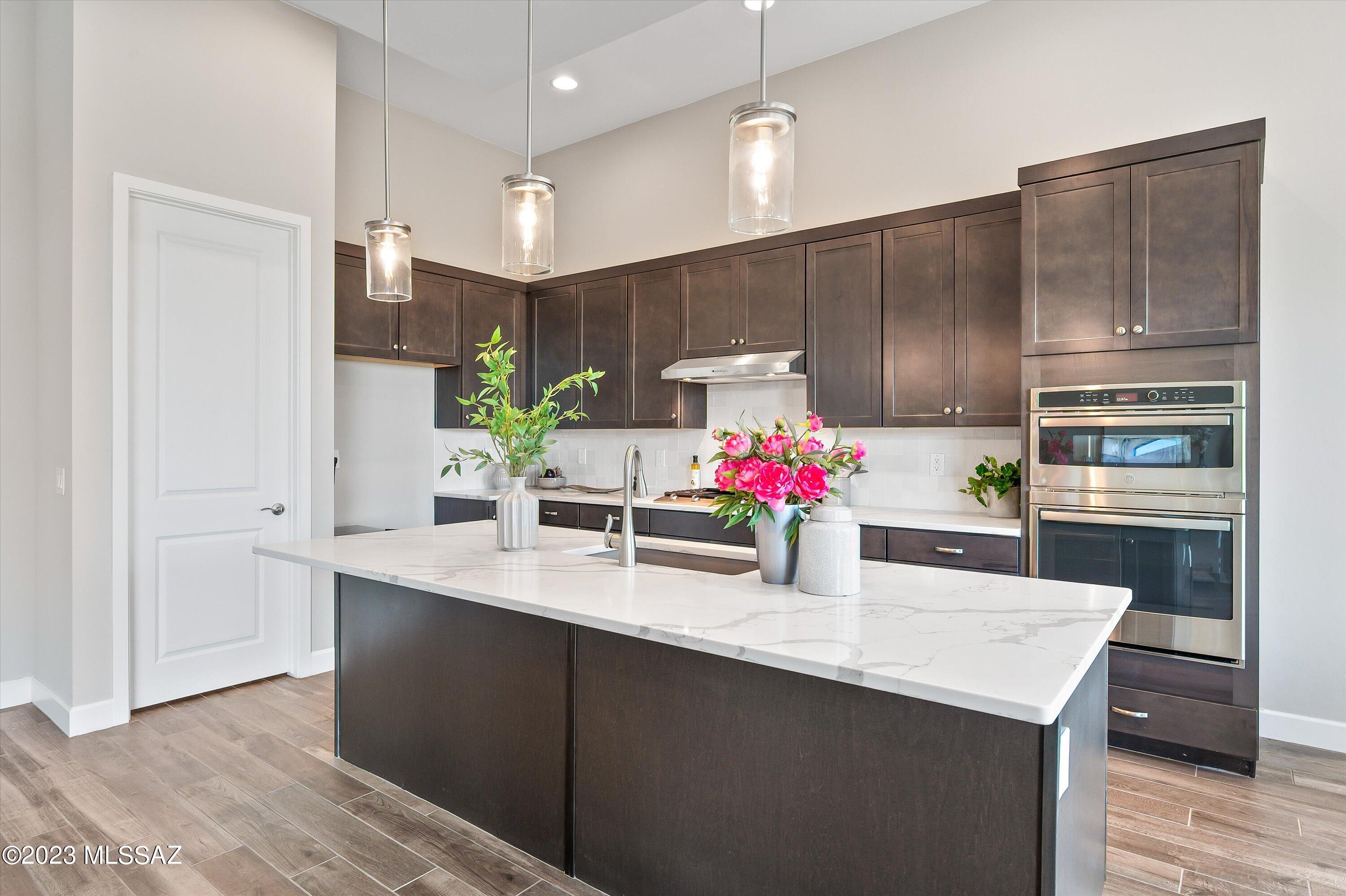 13169 North Vistoso Rnch Place Oro Valley, AZ 85755 - Photo 8 of 29 a kitchen with kitchen island granite countertop a sink cabinets and stainless steel appliances