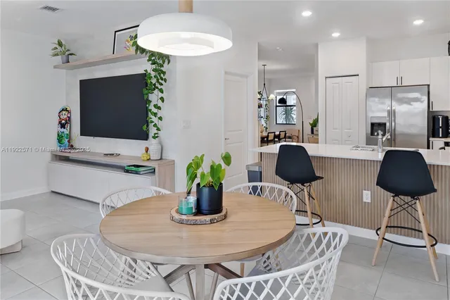 a dining room with furniture and a chandelier